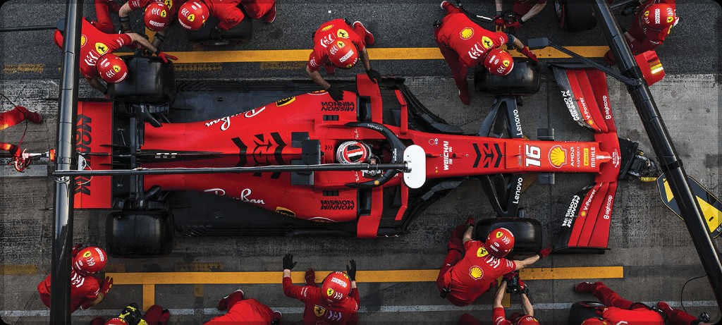 Overhead view of a Formula 1 pit stop crew changing tyres
